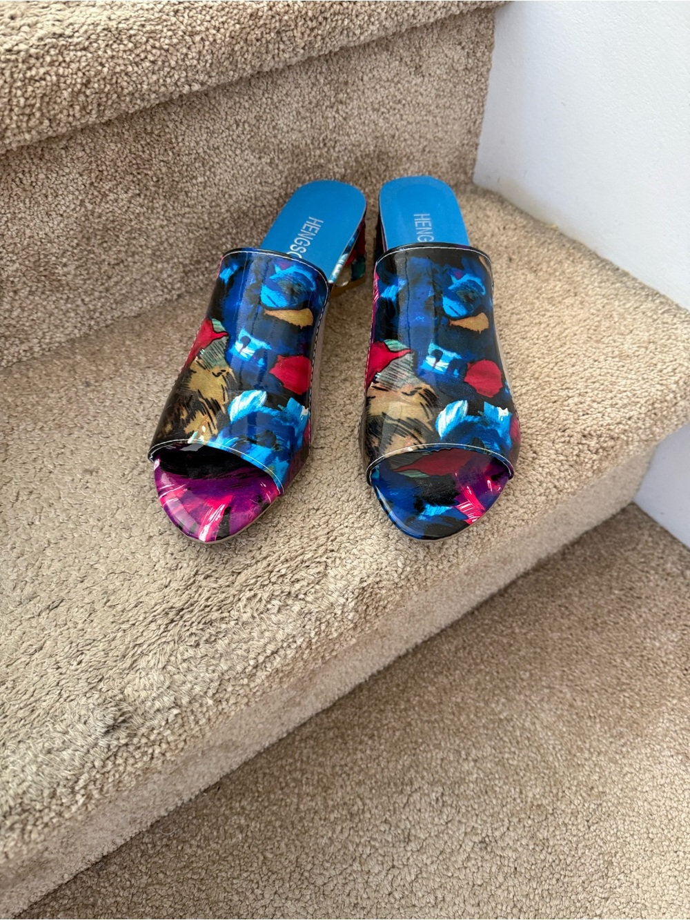 Colorful sandals with decorative faux stones on the heels.